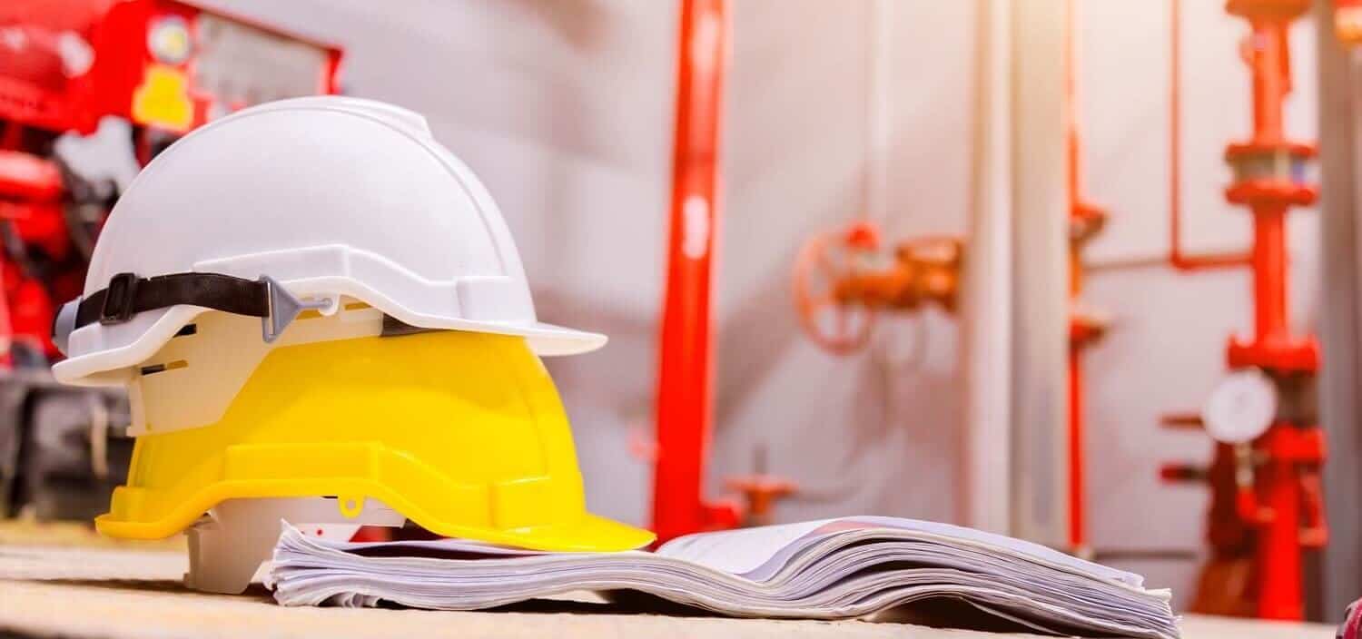 Safety helmets, building plans and fire protection pipework